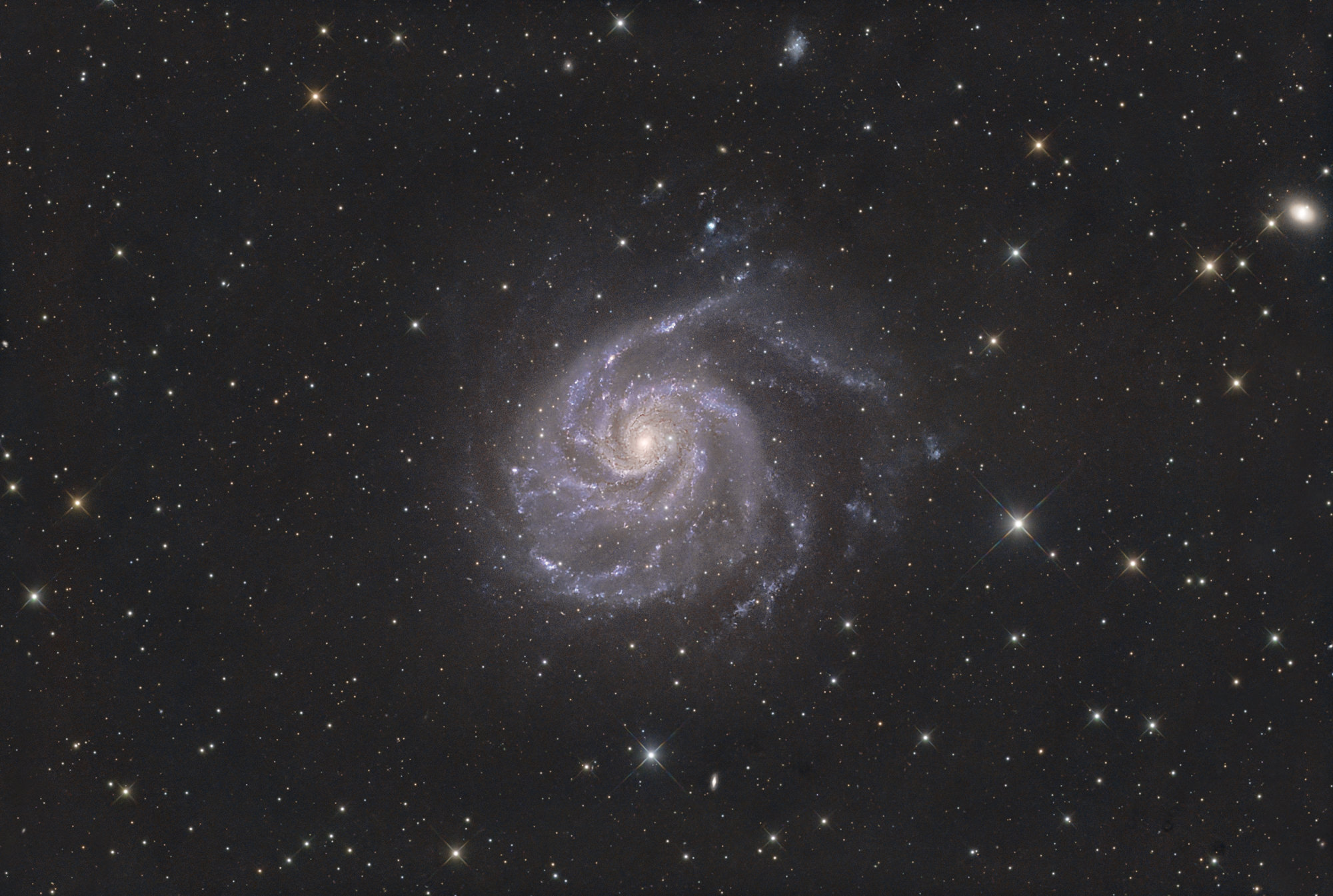 Pinwheel Galaxy, Messier 101 is a face-on unbarred spiral galaxy in the constellation of Ursa Major, the Great Bear. The galaxy is 21 million light-years away from us.